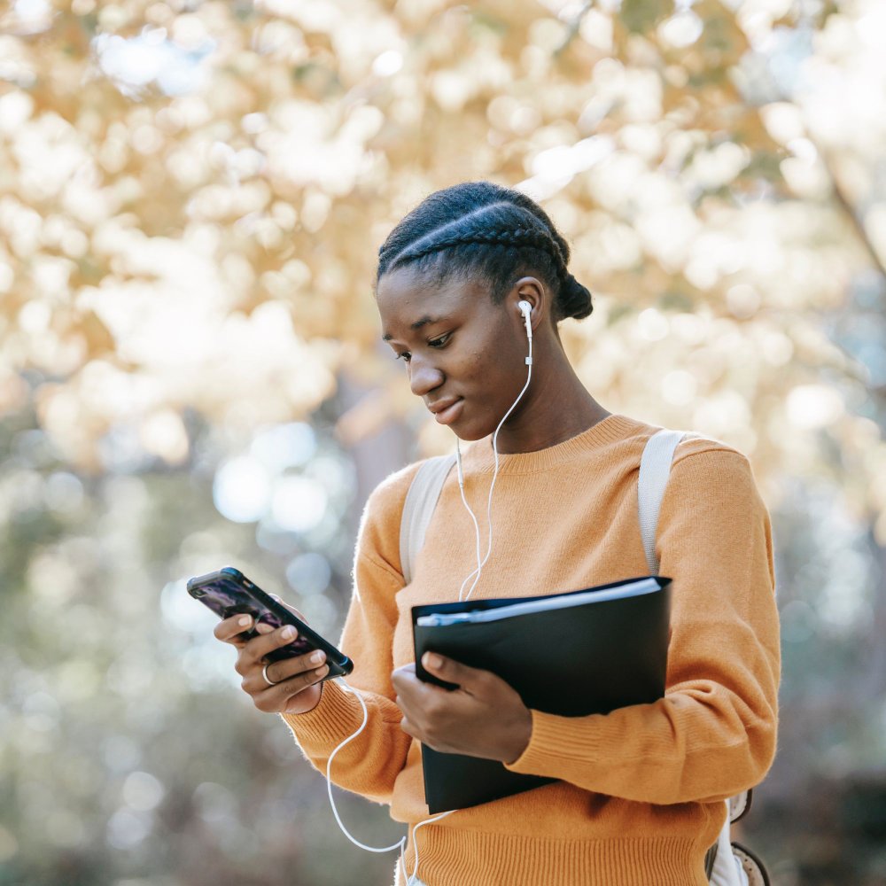 student looking down at phone